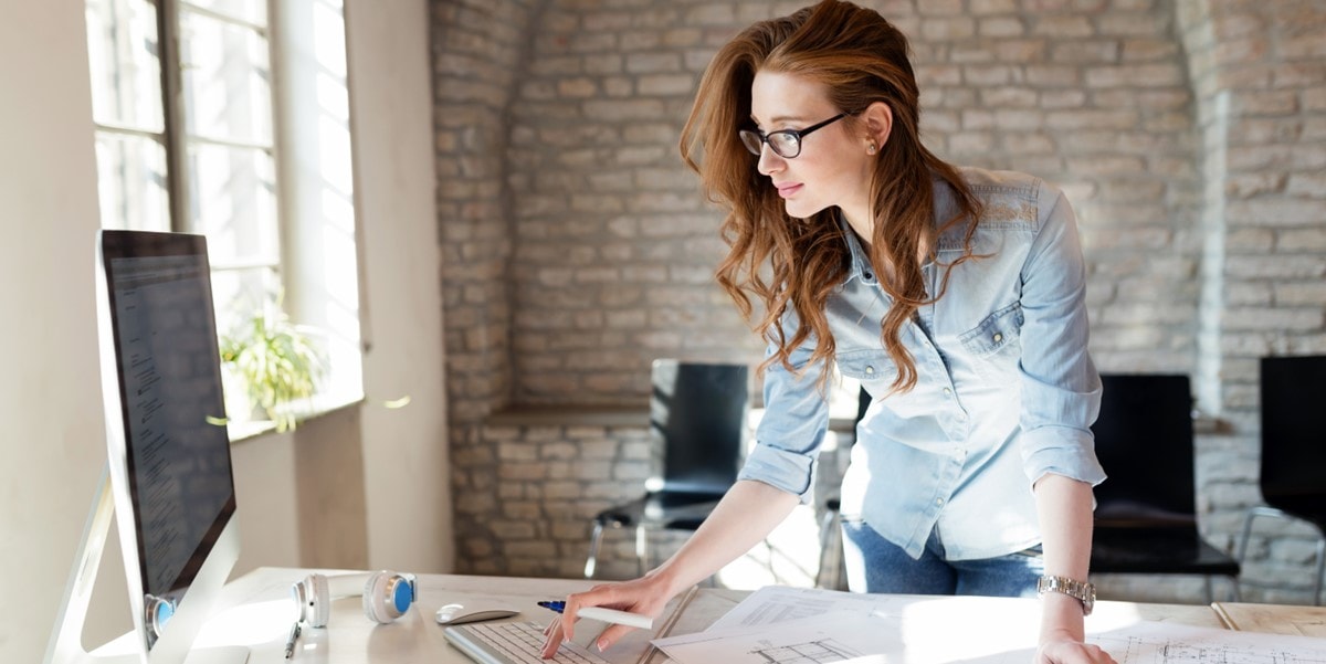 woman in office looking at computer