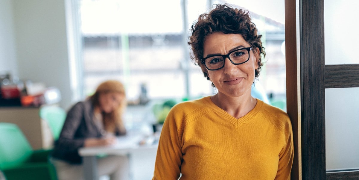 professional woman in office standing at doorway