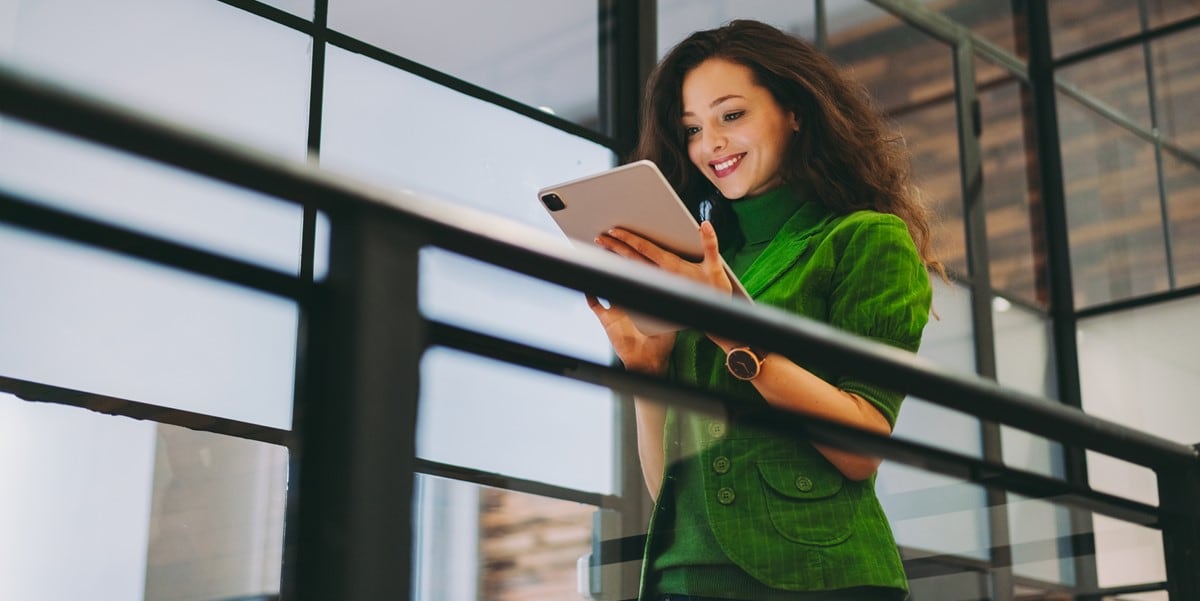 woman in office looking at tablet