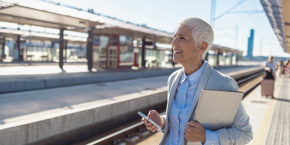 woman with laptop waiting for train