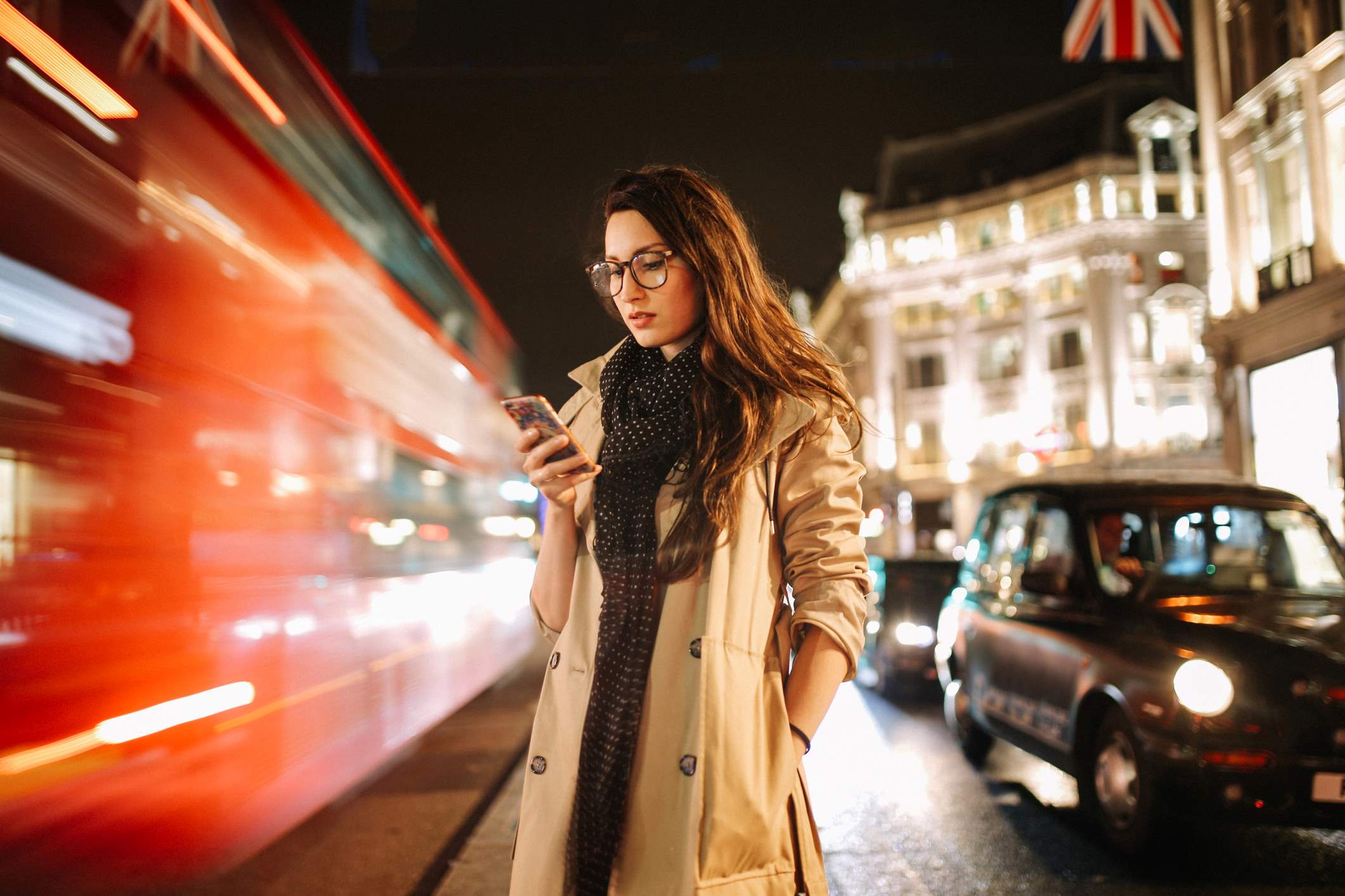 woman_looking_at_her_phone_at_the_street